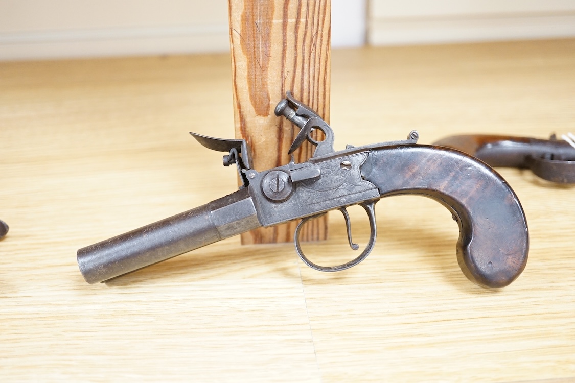 A double barrel flintlock, tap action pocket pistol by Collis of Oxford, with sliding top thumb safety, slab walnut grip, and tower private proof marks